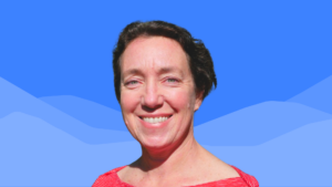 Kate Somers, a smiling woman with short dark hair, wears a red and white top, standing in front of a bright blue background with stylized mountain shapes.